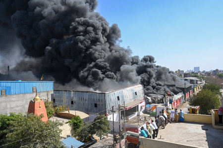 GREATER NOIDA, INDIA - MARCH 31: A massive fire broke out at a factory involved in manufacturing plastic coolers in the Habibpur area in Ecotech-3, on March 31, 2025 in Greater Noida, India. As many as 26 fire tenders were pressed to douse the flames. Polのeditorial素材