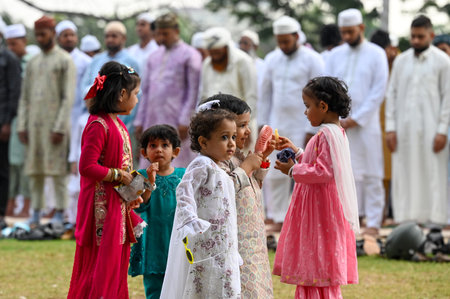 KOLKATA, INDIA - MARCH 31: Kids enjoy playing before the special morning prayer (namaz) on the occasion of Eid al-Fitr festival to marks the the end of Holy fasting month of Ramadan on Red Road on March 31, 2025 in Kolkata, India. Muslims around the worldのeditorial素材