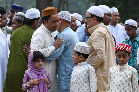 KOLKATA, INDIA - MARCH 31: Muslim devotees hugs after the special morning prayer (namaz) on the occasion of Eid al-Fitr festival to marks the the end of Holy fasting month of Ramadan on Red Road on March 31, 2025 in Kolkata, India. Muslims around the worlのeditorial素材