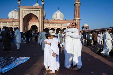 NEW DELHI, INDIA - MARCH 31: Muslims embrace after offering prayers at Jama Masjid on the occasion of Eid-ul-Fitrâ festival, at Jama Masjid in the old quarters of Delhi on March 31, 2025 in New Delhi, India. Muslims around the world are getting into theのeditorial素材