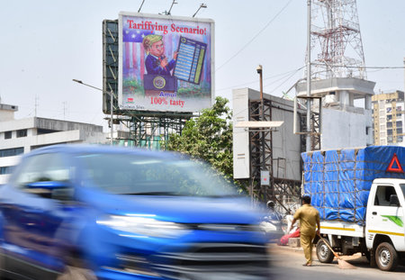 MUMBAI INDIA APRIL 8 2025 An advertisement hoarding by Amul displays cartoon on US president Donald Trumps tariffs at Byculla on April 8 2025 in Mumbai India Amul is known for its topical and humorous advertisements has often commented on current events aのeditorial素材