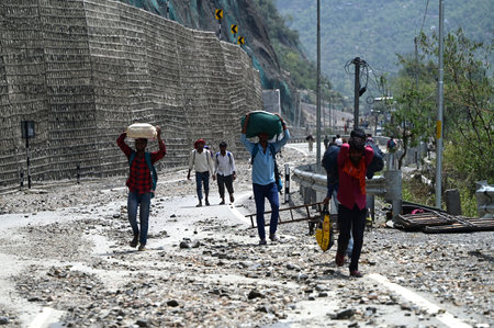 RAMBAN INDIA APRIL 21 2025  People walk on a blocked Srinagar-Jammu national highway after a cloudburst on April 21, 2025 in Ramban, India. A cloudburst triggered flash floods and landslides in Ramban district of Jammu and Kashmir, killing three people, bのeditorial素材