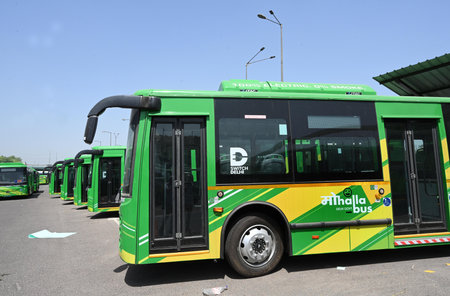 NEW DELHI INDIA APRIL 22 2025 A fleet of DTC DEVI Delhi Electric Vehicle Interconnector electric buses Previously called the mohalla bus service by the Aam Aadmi Party AAP government parked at Kushak drain bus depot whose inauguration has been postponed dのeditorial素材