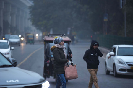 GURUGRAM, INDIA â€“ JANUARY 5: People seen wearing warm clothes while going to office on a cold...