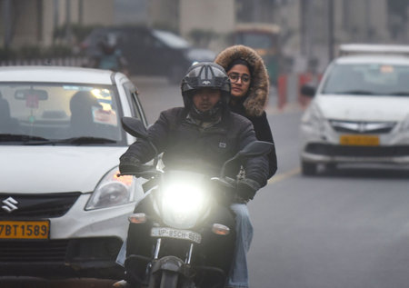 GURUGRAM, INDIA â€“ JANUARY 5: People seen wearing warm clothes while going to office on a cold...