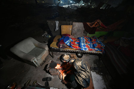 NEW DELHI, INDIA - JANUARY 9: Residents during night hours at Nizamuddin area live on the rubble that was their homes amid cold weather, after MCD demolished around 300 houses -near DPS Mathura road under anti-encroachment drive in December on January 9, のeditorial素材