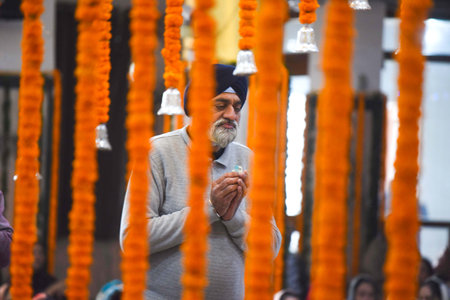 GURUGRAM, INDIA - JANUARY 17:  People praying at Gurdwara Sahib during the celebration of Guru Gobind Singh Prakash Parv of the last Sikh Guru, in New Colony near Police Chowki on January 17, 2024 in Gurugram, India. (Photo by Parveen Kumar/Hindustna Timeのeditorial素材