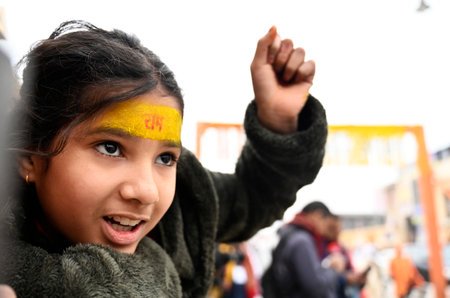 AYODHYA, INDIA - JANUARY 22: A littile girls looks happy watching the consecration ceremony of Shri Ram Janmbhoomi Temple  on January 22, 2024 in Ayodhya, India. Devotees are celebrating the consecration ceremony all over the world with joy and fanfare. Tのeditorial素材