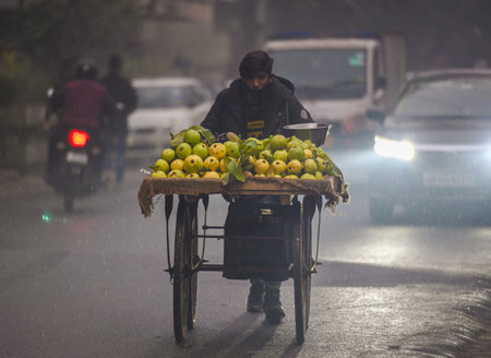NOIDA, INDIA - JANUARY 31: Commuters during light rain in winter, on January 31, 2024 in Noida, India. There was light rain in Delhi NCR on a cold day, which increased the severe cold in North India. There will be light rain in Delhi-NCR today. According のeditorial素材