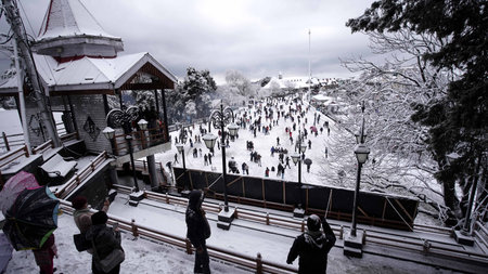 SHIMLA, INDIA -FEBRUARY 1: Tourists and locals enjoy strolling on the snow covered Ridge during...