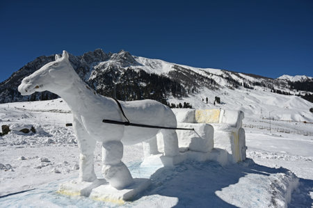SRINAGAR, INDIA --- FEBRUARY 10: A view of a Snow Horse Cart sculpture built on the slopes of Sonamarg, on February 10, 2024 in Srinagar, India. The statue shows a horse pulling a cart through the snow, and it is becoming a big attraction for both locals のeditorial素材