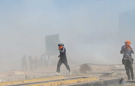 AMBALA, INDIA - FEBRUARY 16:  Security personnel fire tear gas shots to disburse protesters who try...