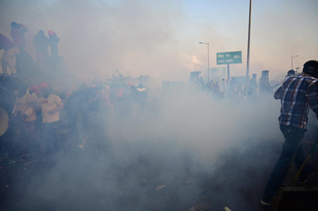 CHANDIGARH, INDIA -FEBRUARY 14: Haryana Police fired Tear gas shells to stop protesters to came near the barricades during the Farmers Protest at Shambu Border of Punjab and Haryana near Ambala, on February 14, 2024 in Chandigarh, India. Police deployed tのeditorial素材