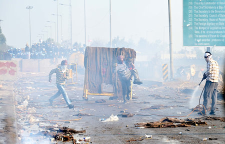 CHANDIGARH, INDIA -FEBRUARY 14: Protesters at barricades during the Farmers Protest at Shambu Border of Punjab and Haryana near Ambala, on February 14, 2024 in Chandigarh, India. Police deployed tear gas to halt thousands of farmers demanding minimum cropのeditorial素材