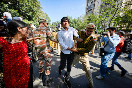 NEW DELHI, INDIA - MARCH 5:  Delhi Police and Paramilitary Security forces try to detaining Akhil Bharatiya Vidyarthi Parishad (ABVP) activists during the demonstration against Mamata Banerjee's government to demand justice for women who have fallen victiのeditorial素材