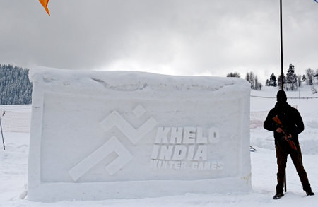 SRINAGAR, INDIA - FEBRUARY 25: Policeman stands guard near a snow sculpture of the Khelo india during a closing ceremony at famous snow covered ski resort, Gulmarg, about 55kms from on February 25, 2024 in Srinagar, India. (Photo by Waseem Andrabi/Hindustのeditorial素材