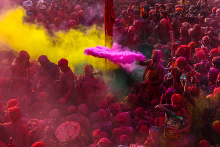 MATHURA, INDIA - MARCH 19: People smear each other with colored powder during the Lathmar Holi...