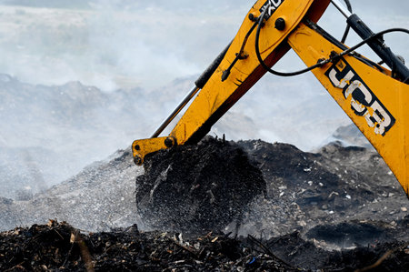 NOIDA, INDIA - MARCH 27: Firefighters try to douse a fire at horticulture waste dumping yard in...