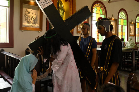 KOLKATA, INDIA - MARCH 29: Christian devotees re-enact the crucifixation of Jesus Christ during Good...