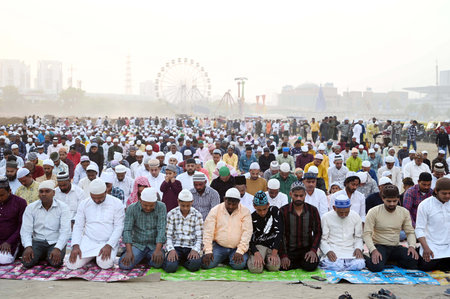 GURUGRAM, INDIA - APRIL 11:  People from the Muslim community offers Namaz on the occasion of Eid-Ul-Fitr which is celebrated by Muslims around the globe to mark the end of the Islamic holy month of Ramadan at sector-29 ground near Leisure Valley Park, inのeditorial素材