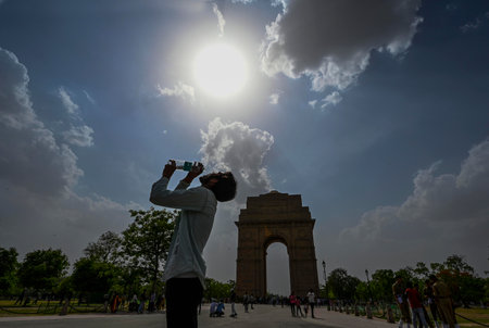 NEW DELHI, INDIA - APRIL 20: Silhouette of a man drinking water from a bottle during a hot summer day,near India Gate on April 20, 2024 in New Delhi, India. (Photo by Raj K Raj/Hindustan Times )のeditorial素材
