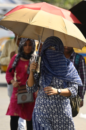 KOLKATA, INDIA - APRIL 25: A commuter covering face with cloth to protect from heat wave on a hot summer day on April 25, 2024 in Kolkata, India. Today the maximum temperature reached 41 degree Celsius in Kolkata. (Photo by Samir Jana/Hindustan Times)のeditorial素材