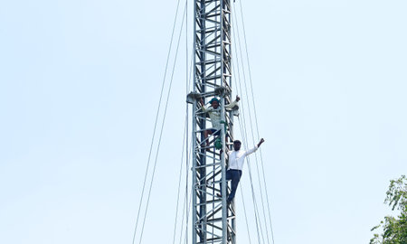 NEW DELHI, INDIA - APRIL 24: Two Tamil Nadu protesting farmers climbed a mobile tower for their...