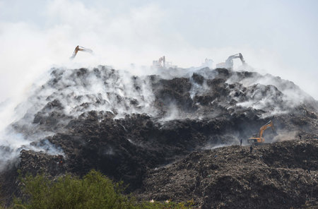 GURUGRAM, INDIA - APRIL 23:  Smoke billowing from a fire that broke out at the waste treatment plant at Gurugram-Faridabad road near Bandhwari Village on April 23, 2024 in Gurugram, India. (Photo by Parveen Kumar/Hindustan Times)のeditorial素材