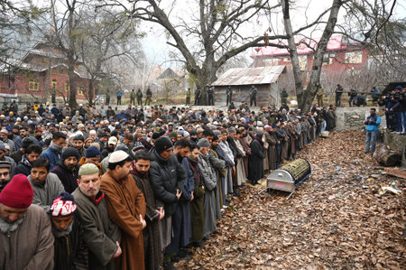 BARAMULLA, INDIA - DECEMBER 24:  Family members and relatives offer prayers near the dead body of retired senior superintendent of police (SSP) Mohammad Shafi during his funeral procession at Gantmulla on December 24, 2023 in Baramulla, India. A retired Sのeditorial素材
