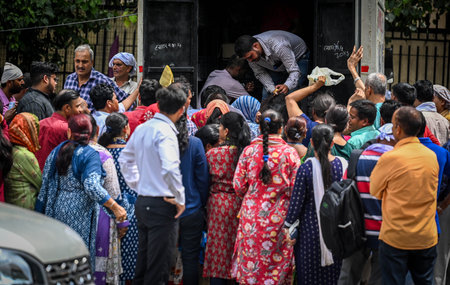 NEW DELHI, INDIA - AUGUST 8: People buy tomatoes at a discounted rate from NCCF Mobile Van at outside Krishi Bhavan on August 8, 2023 in New Delhi, India. The national cooperative consumers' federation (NCCF) and the national agricultural cooperative markのeditorial素材
