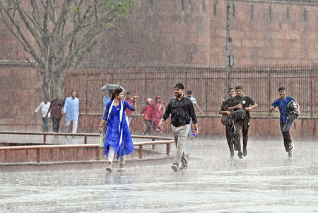 NEW DELHI, INDIA â€“ MAY 3: Visitors out on rain at Red Fort, on May 3, 2023 in New Delhi,...