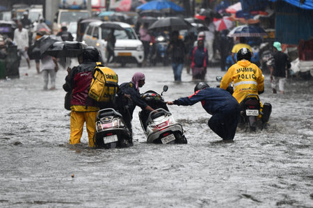 MUMBAI, INDIA â JUNE 28:  People going through logged water during the heavy rain at Bhandup on June 28, 2023 in Mumbai, India. (Photo by Satish Bate/Hindustan Times )のeditorial素材
