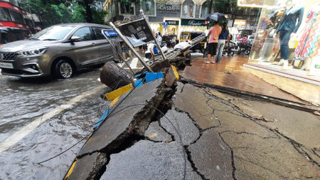MUMBAI, INDIA â JUNE 28: Due to heavy rains in Thane, a big tree on Ram Maruti Road has fallen and the footpath has been damaged ,in Thane, on June 28, 2023 in Mumbai, India. (Photo by Praful Gangurde/Hindustan Times )のeditorial素材