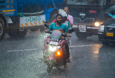 MUMBAI, INDIA - JULY 24:  People going through the heavy rain at Dadar  on June 24, 2023 in Mumbai, India. The weather bureau in its forecast has issued a yellow alert for Mumbai and Thane indicating heavy rains at isolated places.  (Photo by Satish Bate/のeditorial素材