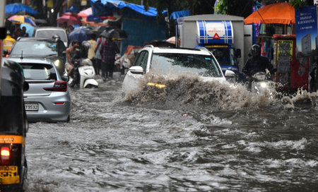 MUMBAI, INDIA â JUNE 28:  People going through logged water during the heavy rain at Bhandup on June 28, 2023 in Mumbai, India. (Photo by Satish Bate/Hindustan Times )のeditorial素材