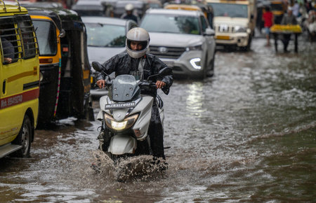 MUMBAI, INDIA â€“ JUNE 28:  People going through logged water during the heavy rain at Bhandup...