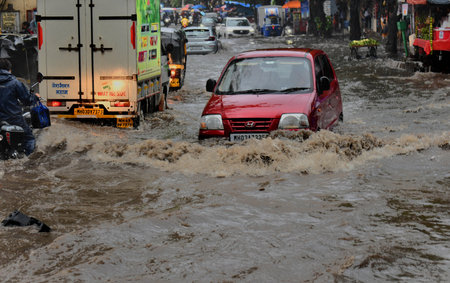 MUMBAI, INDIA â JUNE 28:  People going through logged water during the heavy rain at Bhandup on June 28, 2023 in Mumbai, India. (Photo by Satish Bate/Hindustan Times )のeditorial素材
