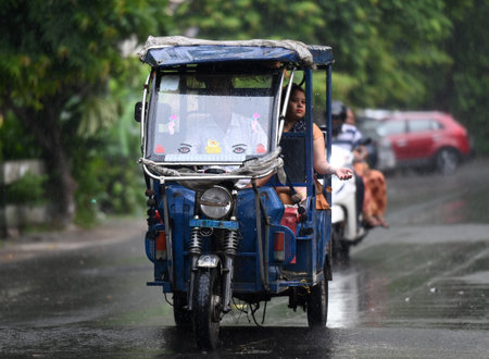 NOIDA, INDIA - JULY 4: Commuters out in the light rain on the Sector 12 road on July 4, 2023 in...