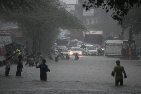 NEW DELHI, INDIA - JULY 8: Commuters seen moving through water logged streets after heavy rainfall at Rohtak Road on July 8, 2023 in New Delhi, India. Delhi-NCR was drenched with heavy rain on the intervening night of Friday and Saturday. The overnight shのeditorial素材