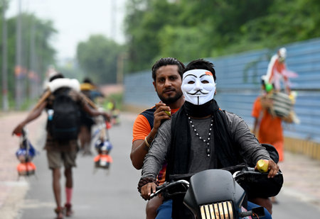 NOIDA, INDIA - JULY 14: Kanwariya carries holy water collected from Ganga River in Haridwar during Kanwar Yatra at Okhla bird sanctuary , in Noida, India, on Friday,14, 2023. (Photo by Sunil Ghosh/Hindustan Times)のeditorial素材
