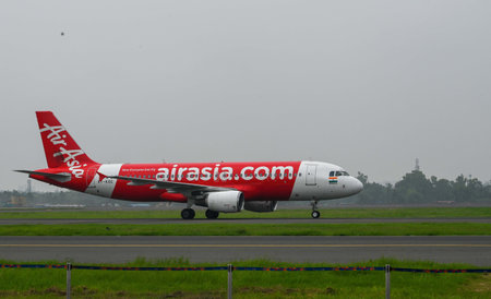 NEW DELHI, INDIA - JULY 14: An Air Asia plane takes off from the newly inaugurated fourth runway of...