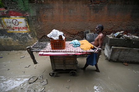 NEW DELHI, INDIA - JULY 17: Locals and residents of Yamuna Bazaar area seen clearing the silt deposited in their houses after the Yamuna River levels gets lowered   on July 17, 2023 in New Delhi, India. (Photo by Sanchit Khanna/ Hindustan Times)のeditorial素材