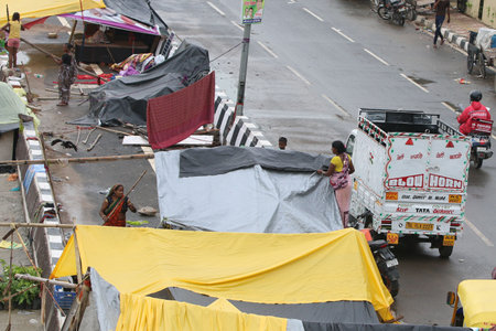 NEW DELHI, INDIA - JULY 26: Flood affected woman working on makeshift, opposite Mayur Vihar, on July 26, 2023 in New Delhi, India. (Photo by Salman Ali/Hindustan Times )のeditorial素材