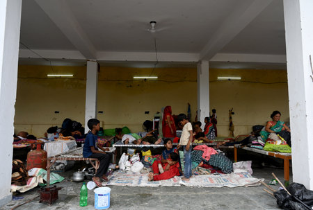 NOIDA, INDIA - JULY 15: People residing near low-lying areas around the Yamuna River in sector 137 relocate to community center after their houses were submerged as the Yamuna River swells up due to monsoon rains, on July 15, 2023 in Noida, India. The watのeditorial素材