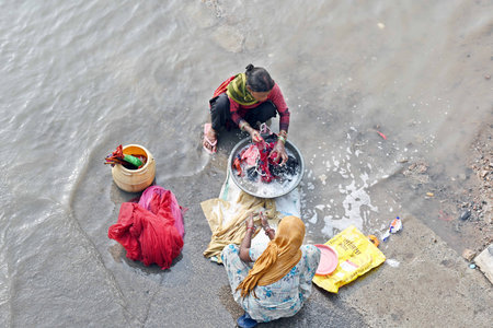 NEW DELHI, INDIA - JULY 16: Locals washing cloths at Yamuna Khadar, after the flood water receded...