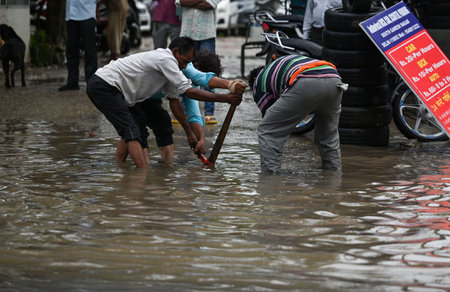 NEW DELHI INDIA JULY 8 2023 MCD workers trying to open the choked drains on a water logged street after heavy rains at Pandav Nagar on July 8 2023 in New Delhi India Delhi NCR was drenched with heavy rain on the intervening night of Friday and Saturday Thのeditorial素材