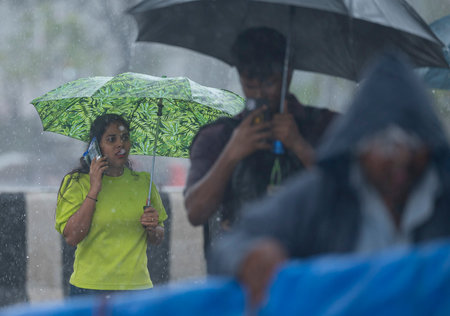MUMBAI INDIA JUNE 30 2023 People dealing with rain at Marine Drives on June 30 2023 in Mumbai India Photo by Anshuman Poyrekar Hindustan Timesのeditorial素材