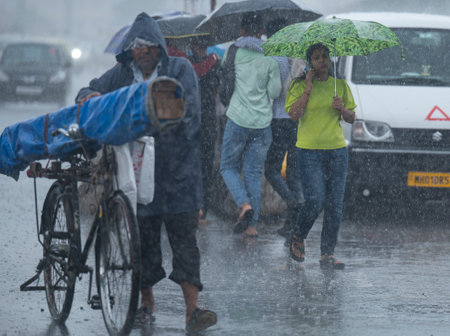 MUMBAI INDIA JUNE 30 2023 People dealing with rain at Marine Drives on June 30 2023 in Mumbai India Photo by Anshuman Poyrekar Hindustan Timesのeditorial素材