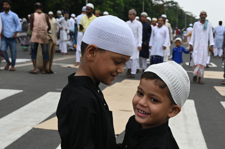 KOLKATA INDIA JUNE 29 2023 Young Muslim devotees after offering prayers on the occasion of Eid ul Adha also known as Feast of Sacrifice or Bakra Eid at Red Road on June 29 2023 in Kolkata India Eid ul Adha also known as Bakra Eid Bakrid Eid al Adha Eid Quのeditorial素材