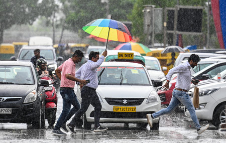 NEW DELHI INDIA JUNE 19 2023 Commuters during sudden rainfall at Connaught Place on June 19 2023 in New Delhi India The city received 5mm of rainfall during the 24 hour period which ended at 830am on Monday The minimum temperature settled at 255 degrees Cのeditorial素材